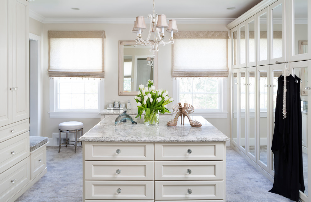 Inspiration for a large transitional women's dressing room in DC Metro with white cabinets, carpet and grey floor.