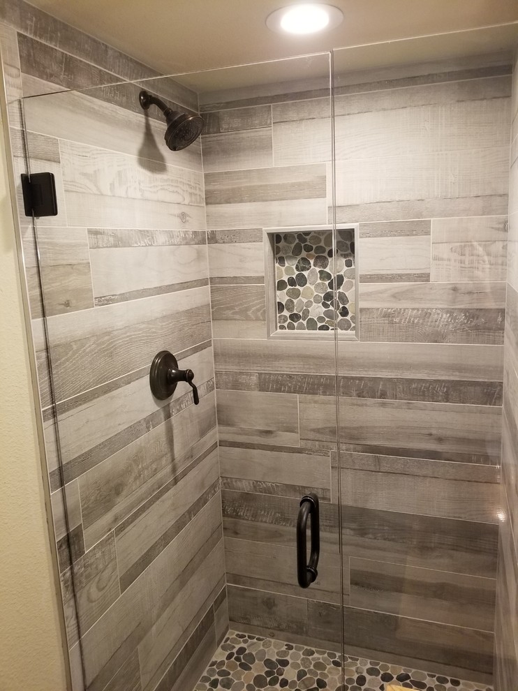 Inspiration for a small country 3/4 bathroom in Dallas with furniture-like cabinets, medium wood cabinets, an alcove shower, a two-piece toilet, gray tile, porcelain tile, beige walls, porcelain floors, a vessel sink, wood benchtops, grey floor, a hinged shower door and brown benchtops.
