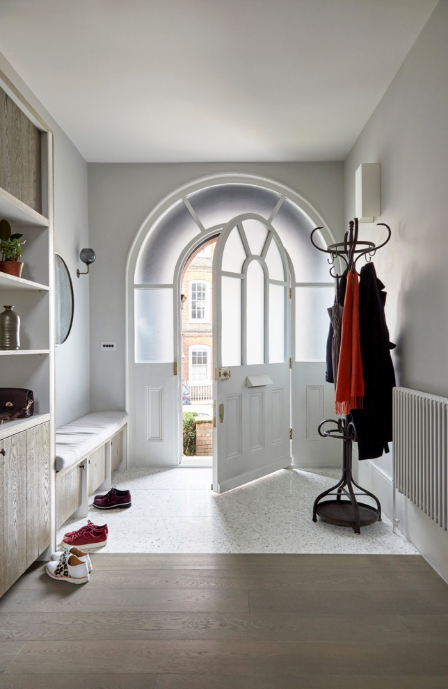Inspiration for a large scandinavian entryway in London with beige walls and terrazzo floors.