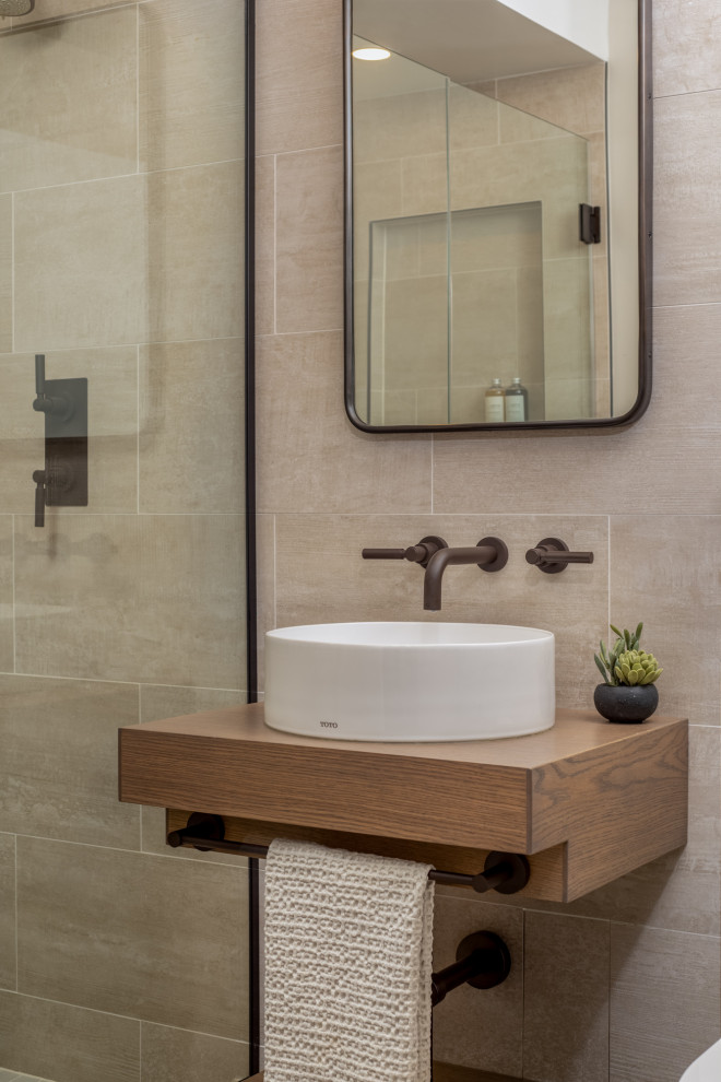 Inspiration for a small contemporary powder room in Chicago with beige tile, beige walls, a vessel sink, wood benchtops, brown benchtops, a floating vanity, medium wood cabinets, porcelain tile and porcelain floors.
