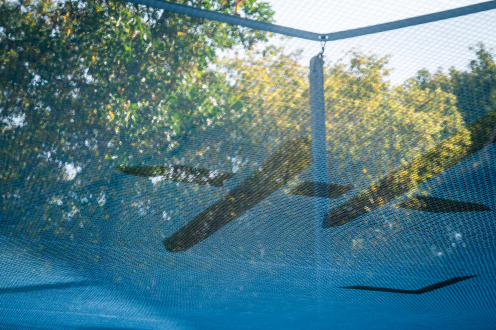 Inspiration for a large modern partial sun backyard outdoor basketball/tennis/multi-game court for summer.