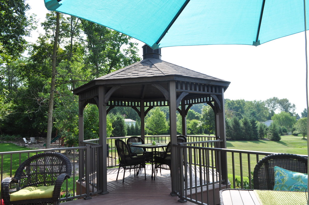 Inspiration for a mid-sized transitional backyard deck remodel with a pergola