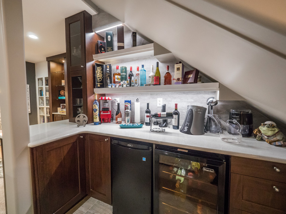 Inspiration for a small transitional single-wall wet bar in Other with carpet, brown floor, shaker cabinets, dark wood cabinets, quartz benchtops, grey splashback and white benchtop.