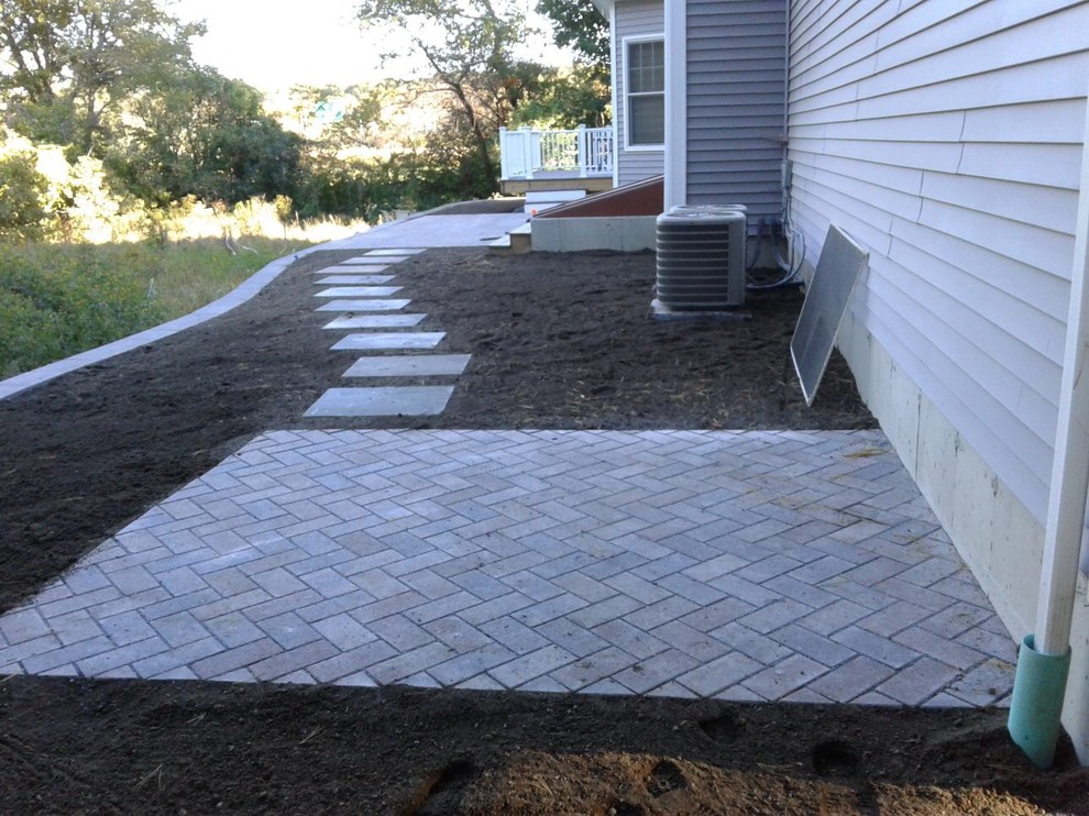 Design ideas for a small traditional backyard patio in Boston with brick pavers and no cover.