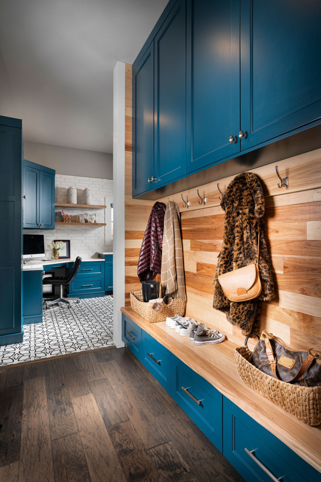 This is an example of a large transitional utility room in Other with an undermount sink, blue cabinets, white walls, dark hardwood floors, a side-by-side washer and dryer, brown floor, white benchtop, quartz benchtops and recessed-panel cabinets.