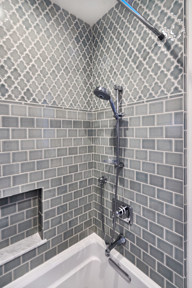 This is an example of a mid-sized transitional 3/4 bathroom in San Francisco with recessed-panel cabinets, grey cabinets, an alcove tub, a shower/bathtub combo, a two-piece toilet, gray tile, porcelain tile, grey walls, an undermount sink, marble benchtops and a shower curtain.