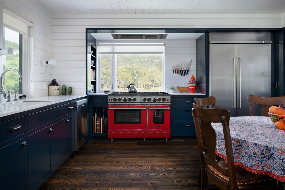 This is an example of a country separate kitchen in Austin with a drop-in sink, turquoise cabinets, quartz benchtops, white splashback, dark hardwood floors, brown floor and yellow benchtop.