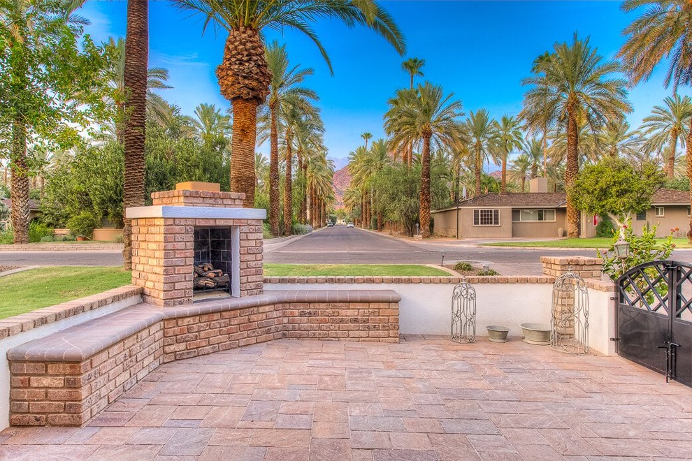 Inspiration for a mid-sized transitional front yard brick patio remodel in Phoenix with a fire pit and no cover