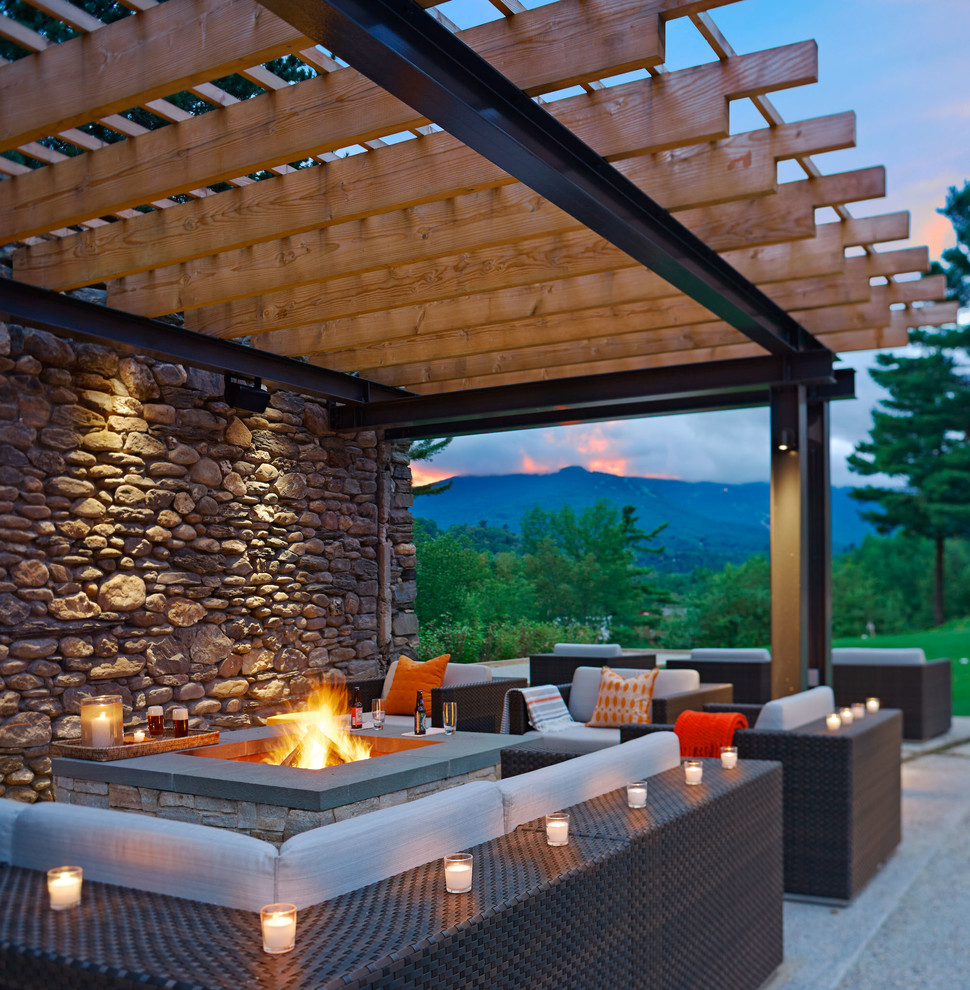 Mid-sized contemporary backyard patio in Burlington with a fire feature and a pergola.