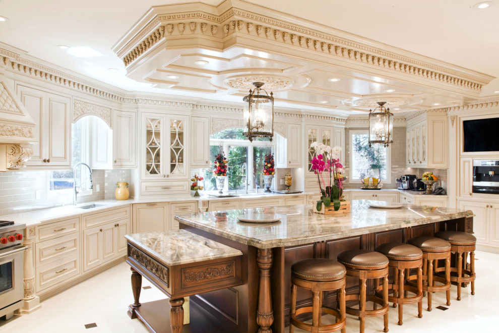 Photo of a large classic u-shaped enclosed kitchen in New York with a built-in sink, shaker cabinets, distressed cabinets, engineered stone countertops, beige splashback, ceramic splashback, stainless steel appliances, an island, white floors, beige worktops and a wood ceiling.