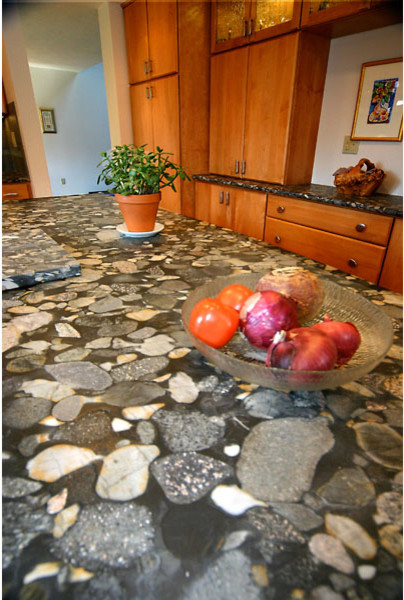 Example of a mid-sized u-shaped light wood floor kitchen pantry design in Boston with an undermount sink, flat-panel cabinets, light wood cabinets, granite countertops, gray backsplash, ceramic backsplash, stainless steel appliances and an island
