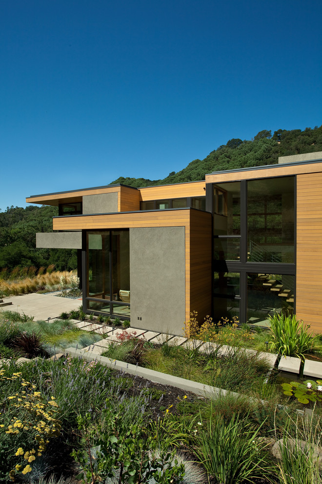 Design ideas for a mid-sized modern two-storey exterior in San Francisco with mixed siding and a flat roof.