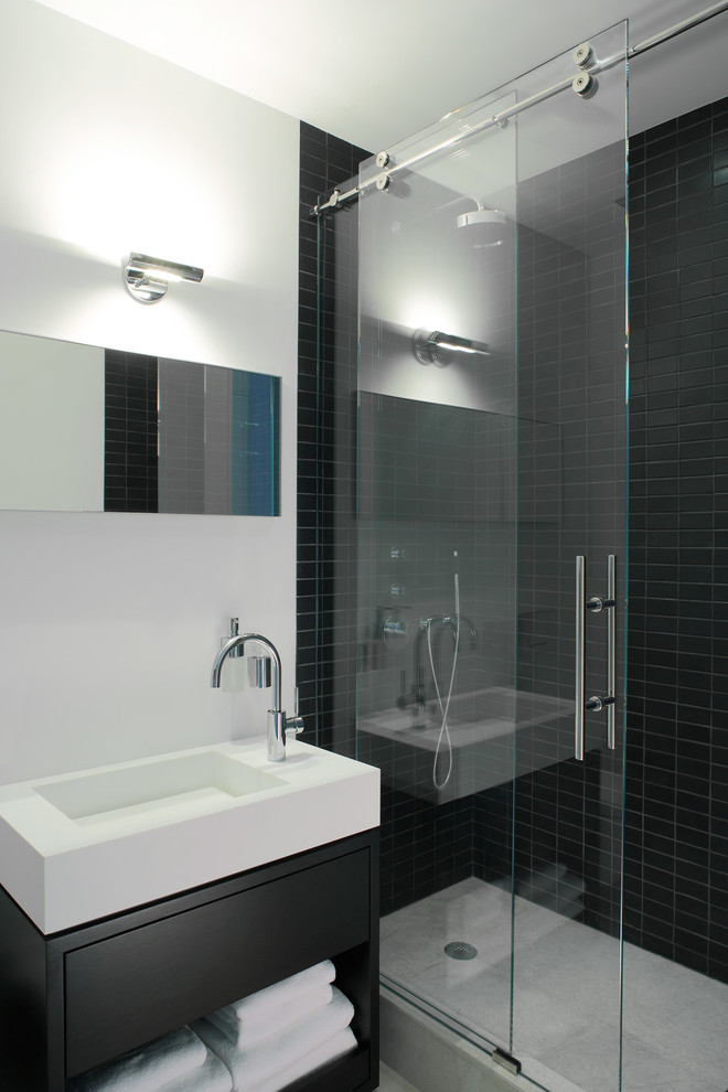 Design ideas for a contemporary bathroom in New York with open cabinets, an alcove shower, black tile, ceramic tile, an integrated sink and black cabinets.