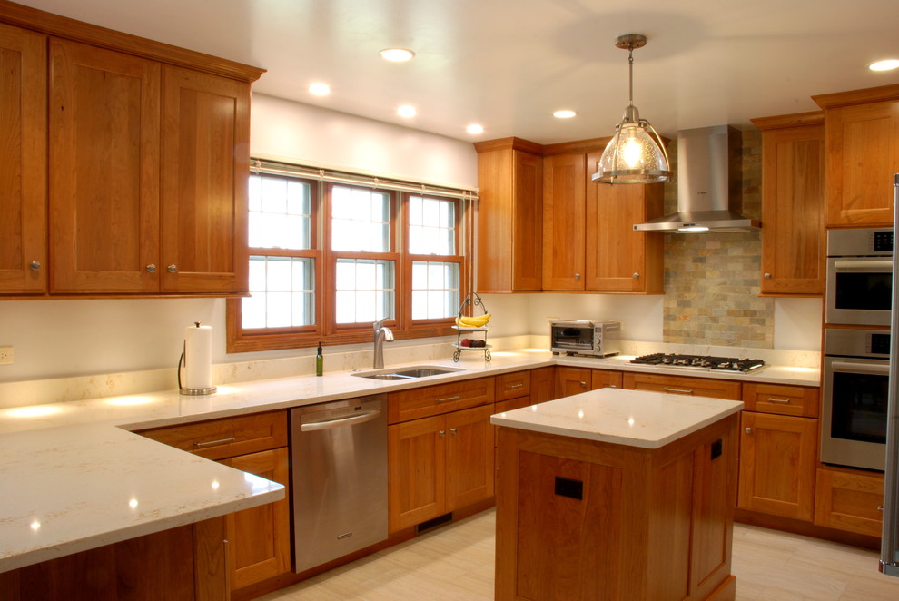 Design ideas for a kitchen in Chicago with an undermount sink, flat-panel cabinets, medium wood cabinets, quartz benchtops, stone tile splashback, stainless steel appliances, ceramic floors and multiple islands.