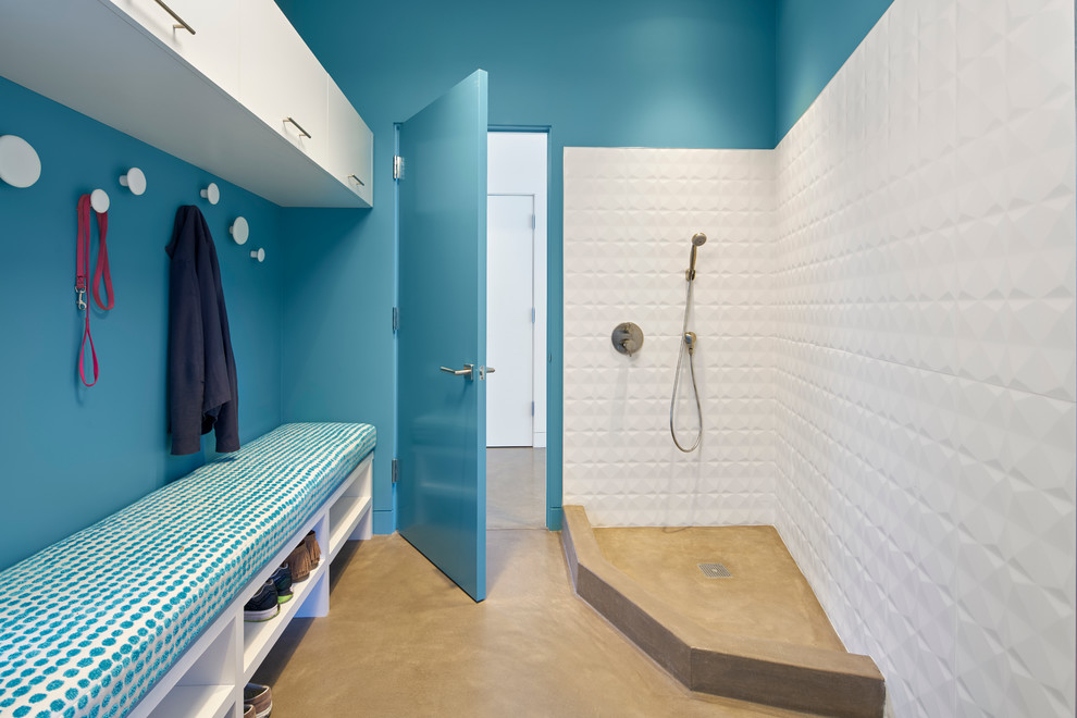 Inspiration for a mid-sized contemporary single-wall utility room in San Francisco with flat-panel cabinets, white cabinets, blue walls, concrete floors and beige floor.