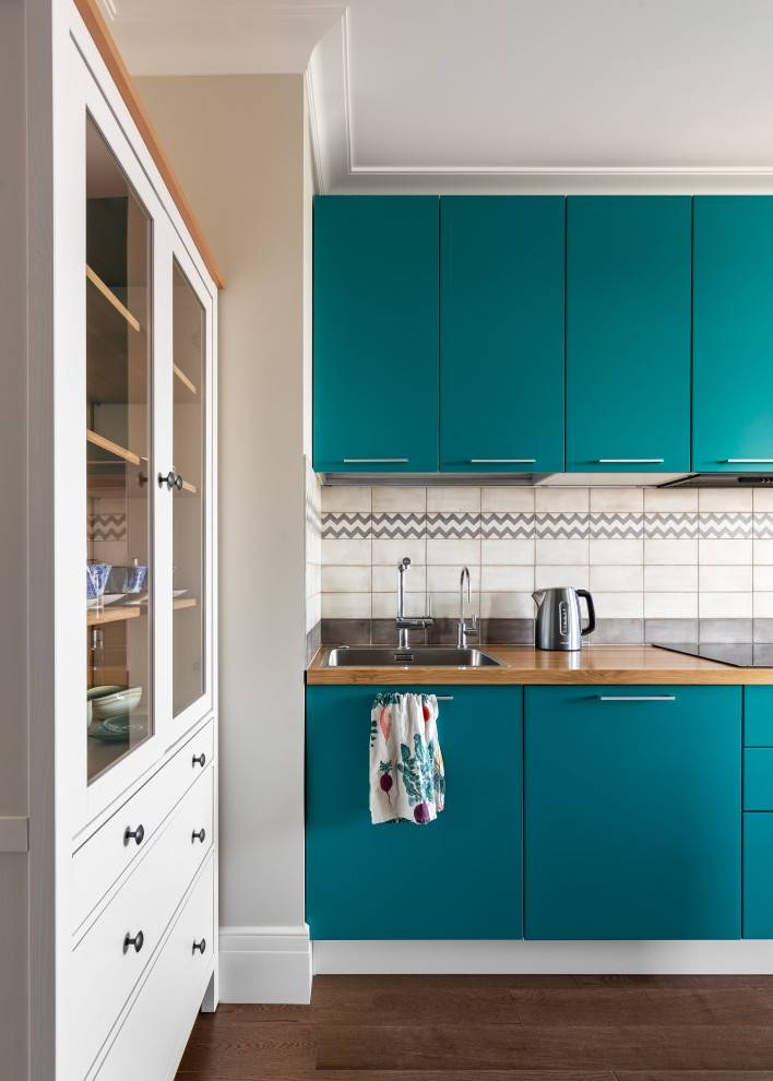 Inspiration for a mid-sized galley eat-in kitchen in Saint Petersburg with an undermount sink, flat-panel cabinets, turquoise cabinets, wood benchtops and white splashback.