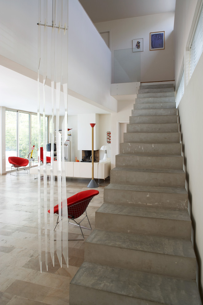 This is an example of a large contemporary concrete straight staircase in Montpellier with concrete risers.
