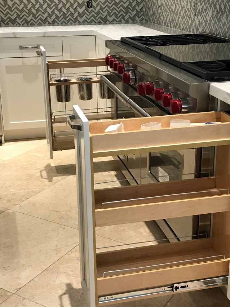 Large transitional kitchen photo in Miami with a farmhouse sink, shaker cabinets, white cabinets, quartz countertops, gray backsplash, glass tile backsplash, stainless steel appliances, an island and multicolored countertops