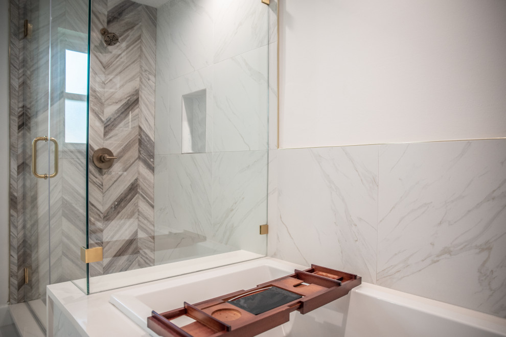 Inspiration for a mid-sized beach style master bathroom in Houston with shaker cabinets, medium wood cabinets, a drop-in tub, a shower/bathtub combo, a one-piece toilet, white tile, ceramic tile, white walls, porcelain floors, an undermount sink, quartzite benchtops, white floor, a hinged shower door and white benchtops.