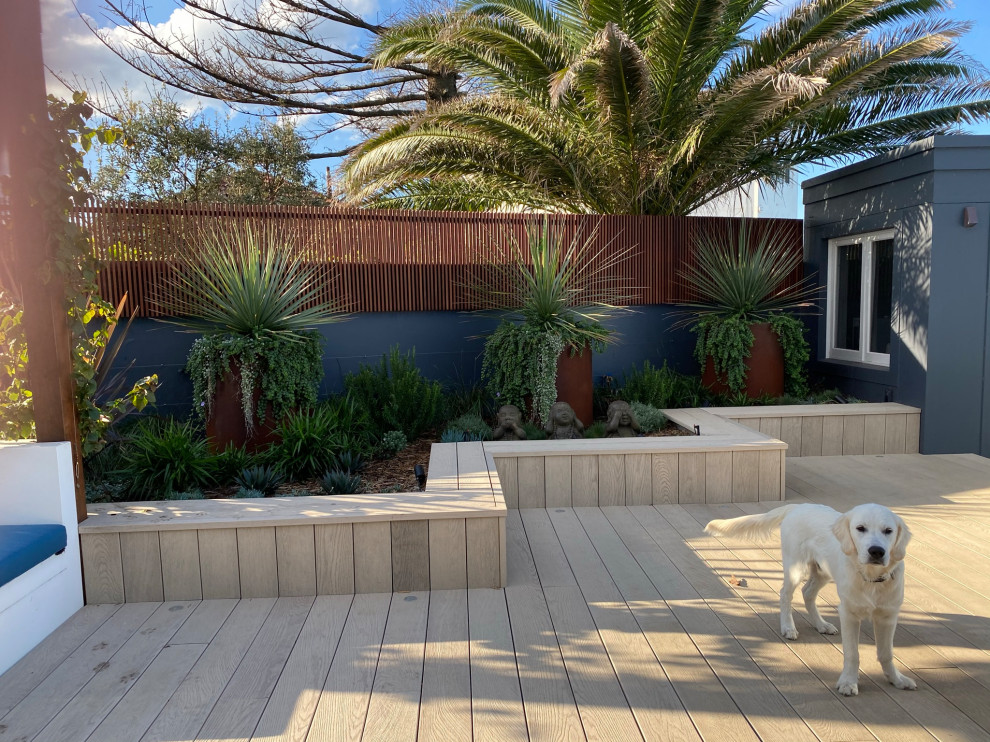 Foto di un giardino moderno esposto in pieno sole di medie dimensioni e dietro casa con pedane e recinzione in legno