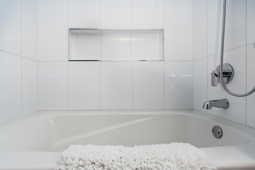 Design ideas for a small contemporary master bathroom in Vancouver with flat-panel cabinets, black cabinets, an alcove tub, a shower/bathtub combo, a two-piece toilet, gray tile, porcelain tile, white walls, porcelain floors, an undermount sink and quartzite benchtops.
