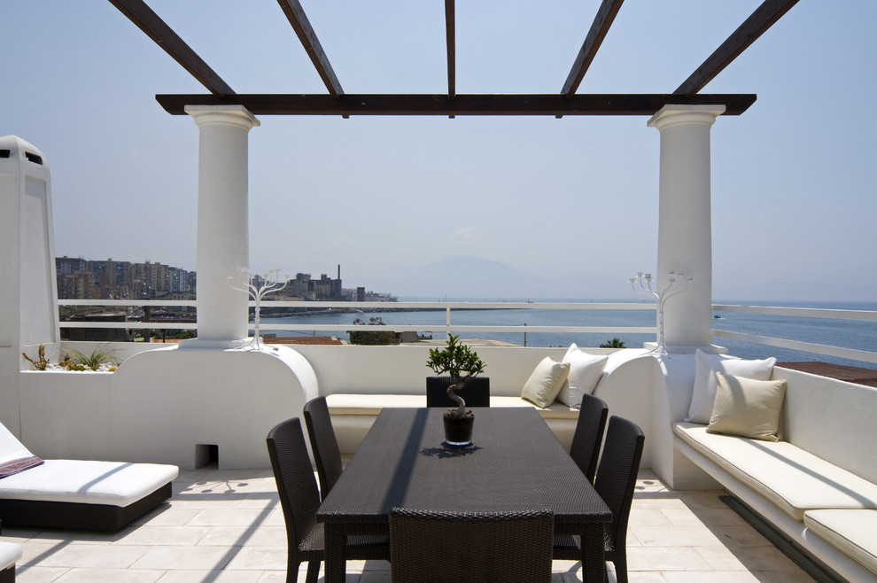Inspiration for an expansive mediterranean rooftop and rooftop deck in Rome with a pergola.