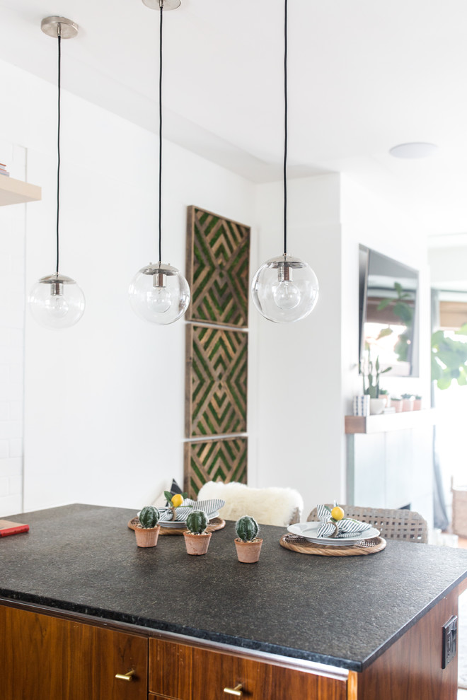 Design ideas for a mid-sized eclectic l-shaped open plan kitchen in San Francisco with a single-bowl sink, flat-panel cabinets, brown cabinets, concrete benchtops, white splashback, subway tile splashback, stainless steel appliances, dark hardwood floors, with island and brown floor.