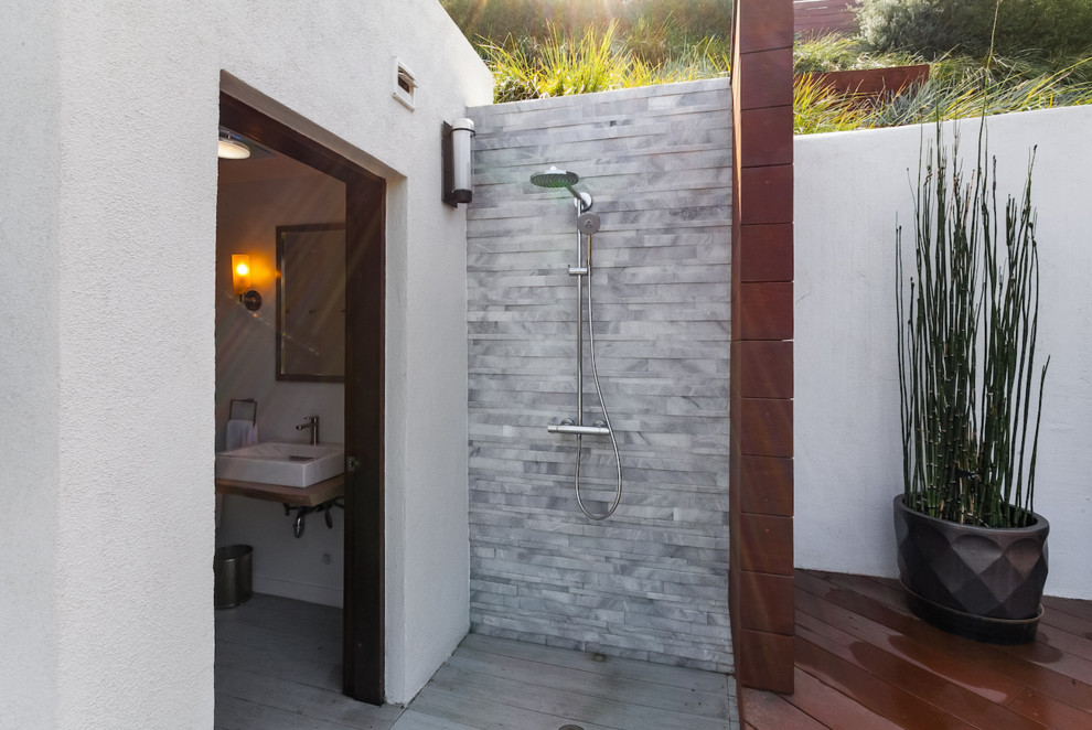 Large contemporary backyard patio in Los Angeles with an outdoor shower and concrete pavers.