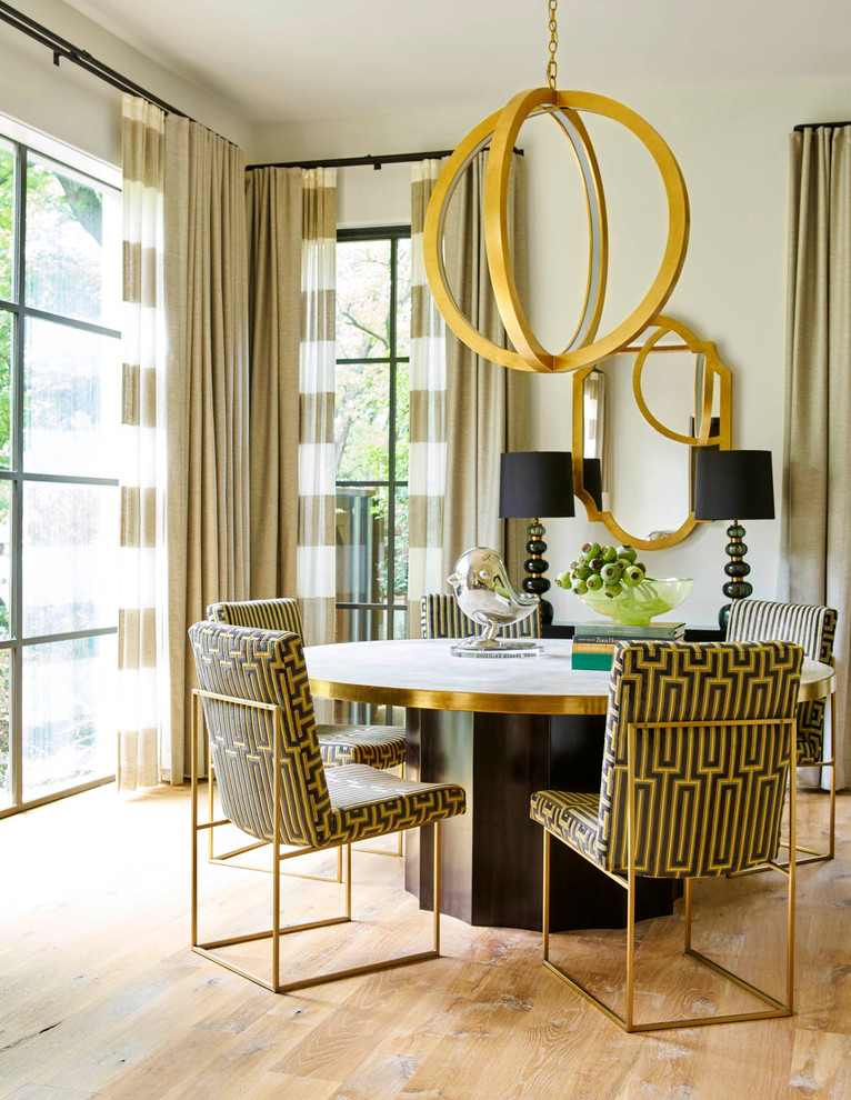 This is an example of a contemporary dining room in Dallas with beige walls and light hardwood floors.