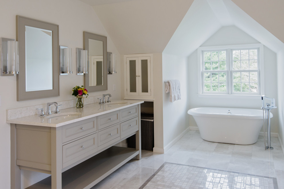 Design ideas for a large traditional master bathroom in Bridgeport with recessed-panel cabinets, grey cabinets, a freestanding tub, a double shower, a one-piece toilet, gray tile, stone tile, grey walls, marble floors, an undermount sink and marble benchtops.