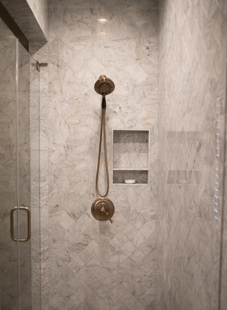 Example of a large transitional master white tile and marble tile porcelain tile and gray floor corner shower design with shaker cabinets, dark wood cabinets, an undermount tub, a one-piece toilet, brown walls, an undermount sink, quartz countertops, a hinged shower door and white countertops