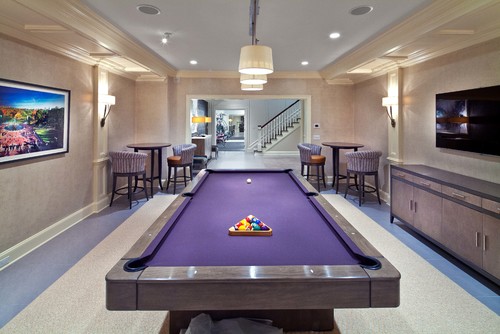 Billiard or game room featuring two pub tables and bar stools