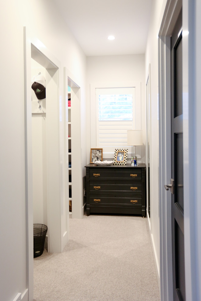 Design ideas for a mid-sized transitional gender-neutral walk-in wardrobe in Other with open cabinets, white cabinets, carpet and grey floor.
