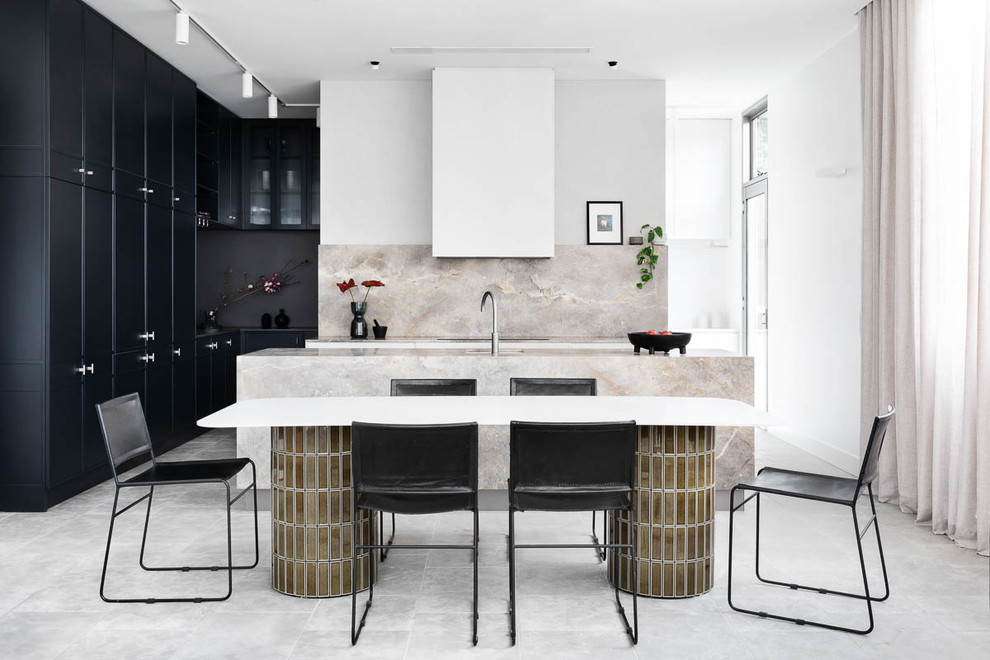 This is an example of a large contemporary l-shaped open plan kitchen in Melbourne with with island, grey floor, black cabinets, beige splashback and beige benchtop.