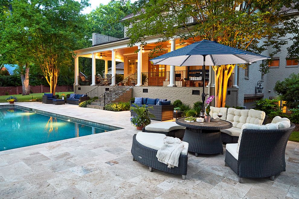 Inspiration for a midcentury backyard rectangular pool in Charlotte with with a pool and natural stone pavers.