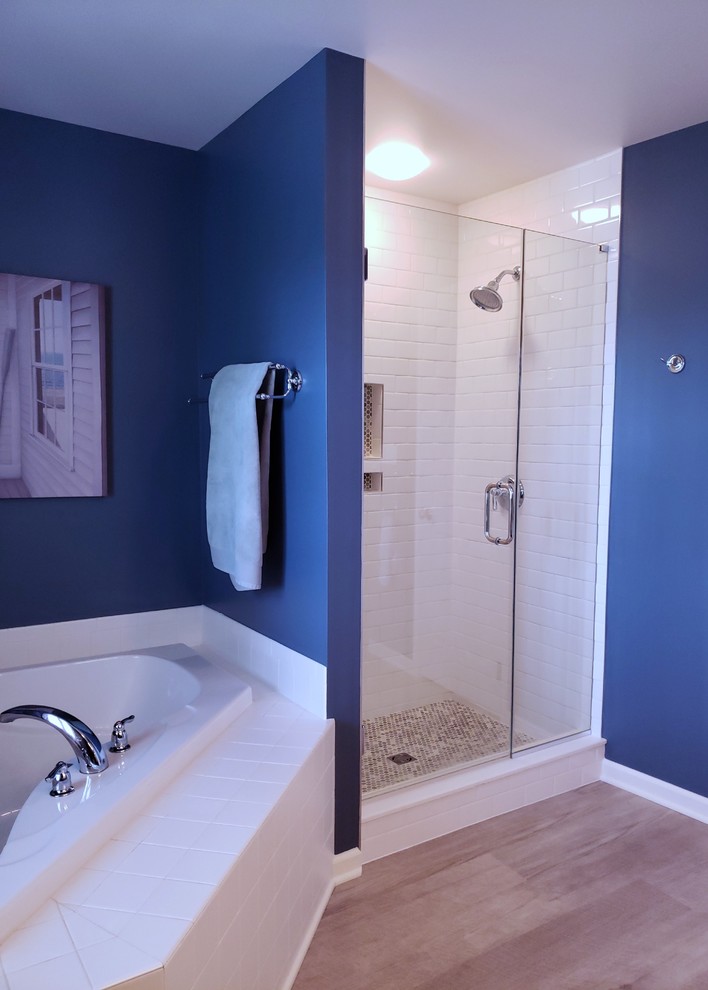 Photo of a modern bathroom in Other with a corner tub and a hinged shower door.