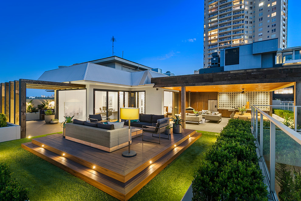 Inspiration for a large modern courtyard patio in Sydney with an outdoor kitchen, brick pavers and a pergola.