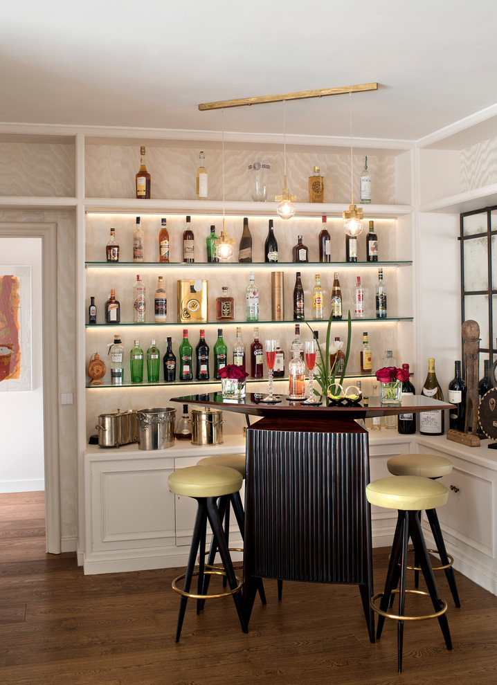 Photo of a small transitional single-wall seated home bar in Barcelona with open cabinets, white cabinets, wood benchtops, dark hardwood floors and brown floor.