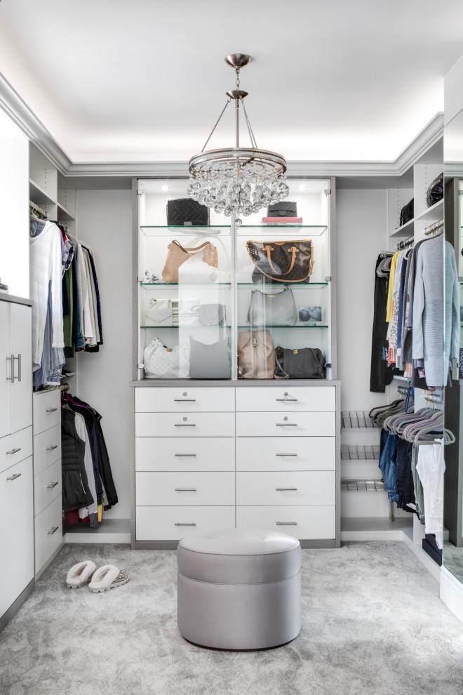 Inspiration for a mid-sized mediterranean women's walk-in wardrobe in Los Angeles with flat-panel cabinets, white cabinets, carpet and grey floor.