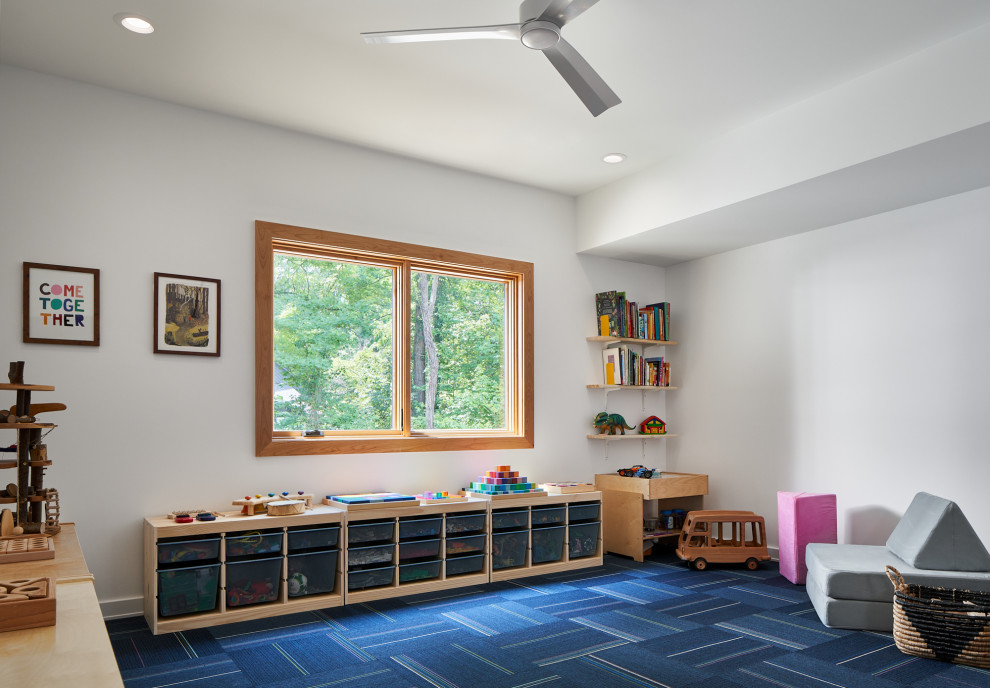 Design ideas for a mid-sized midcentury gender-neutral kids' playroom for kids 4-10 years old in Atlanta with white walls, carpet and blue floor.