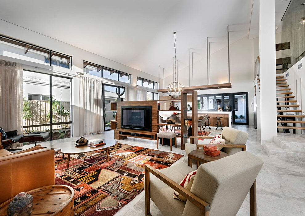 Expansive contemporary loft-style living room in Perth with white walls, travertine floors and a built-in media wall.