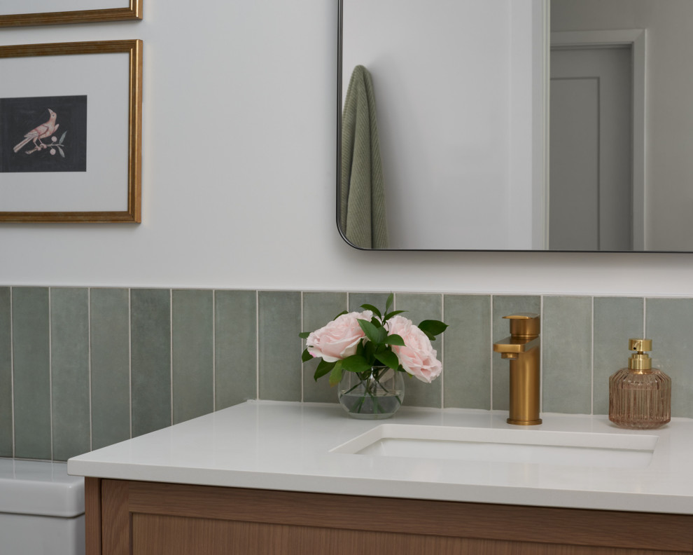Inspiration for a small transitional green tile and porcelain tile porcelain tile, beige floor, single-sink and wainscoting bathroom remodel in Toronto with shaker cabinets, medium tone wood cabinets, a one-piece toilet, white walls, an undermount sink, quartz countertops, white countertops, a niche and a freestanding vanity