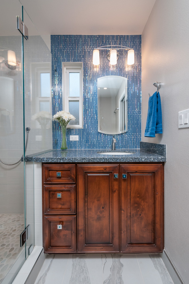 Example of a small beach style master blue tile and glass tile porcelain tile corner shower design in San Francisco with an undermount sink, raised-panel cabinets, dark wood cabinets, quartz countertops and gray walls