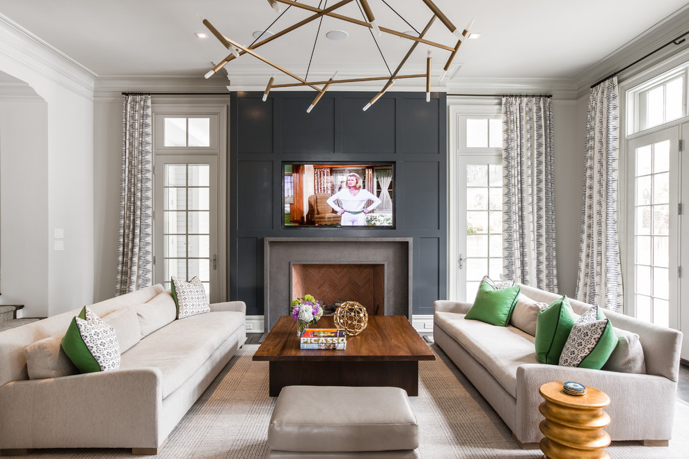 Photo of a transitional formal living room in New York with white walls, a standard fireplace, a stone fireplace surround and a wall-mounted tv.