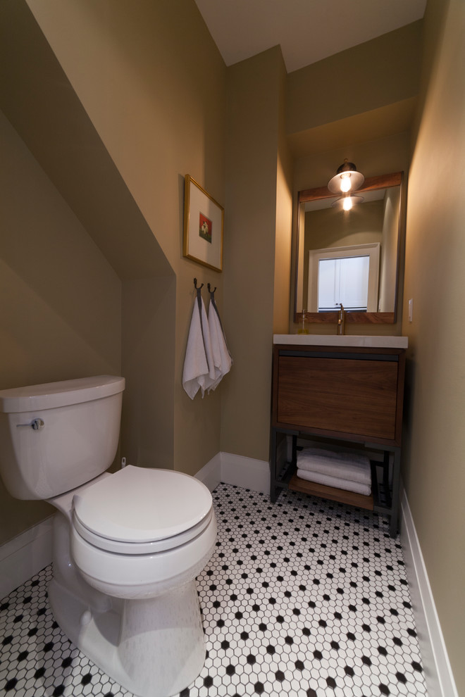 Photo of a small eclectic powder room in Other with furniture-like cabinets, distressed cabinets, a two-piece toilet, black and white tile, mosaic tile floors, an undermount sink, engineered quartz benchtops, mosaic tile and yellow walls.