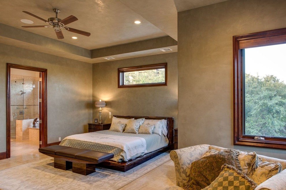 Photo of a large traditional master bedroom in Austin with grey walls, marble floors, no fireplace and beige floor.