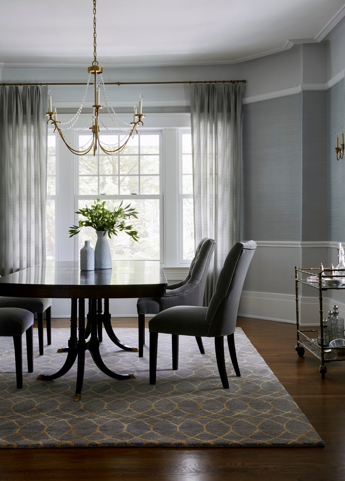 This is an example of a large traditional dining room in New York with grey walls, no fireplace and carpet.