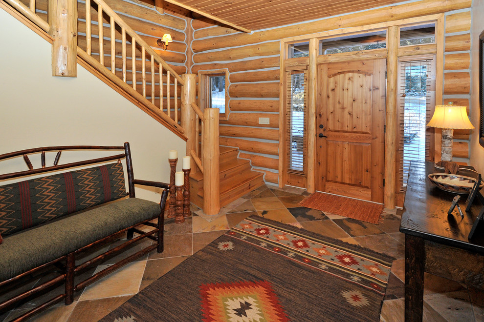 Inspiration for a mid-sized rustic slate floor foyer remodel with a light wood front door
