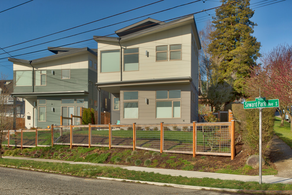 This is an example of a mid-sized modern two-storey townhouse exterior in Seattle with concrete fiberboard siding.