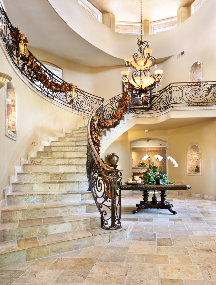 Design ideas for a mediterranean limestone curved staircase in Los Angeles with limestone risers.